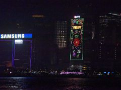 10A CITIC Tower is colourfully lit up at night close up from Star Ferry Hong Kong